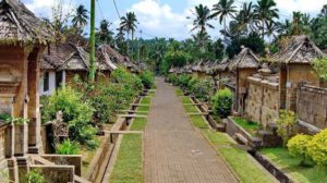 Traditional Balinese gateway and moss-covered stone path at the famous Penglipuran Village in Bali.